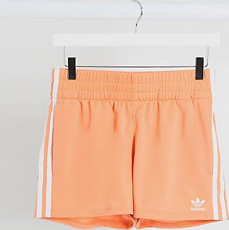 adidas originals three stripe cigarette pants in orange