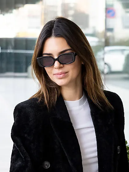 Who made Kendall Jenner's aviator sunglasses, pink wallet, key