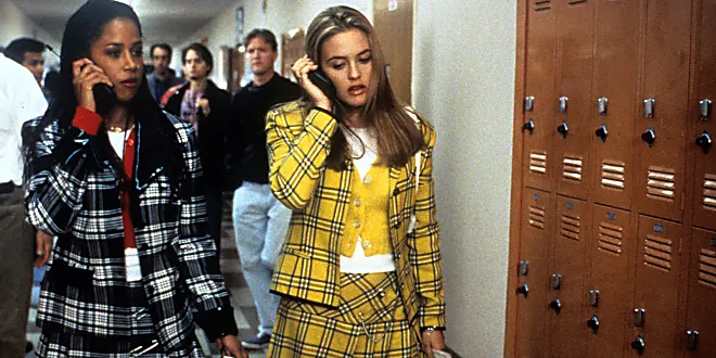 Cher Horowitz in the 90's film Clueless, wearing a yellow plaid skirt and jacket ensemble