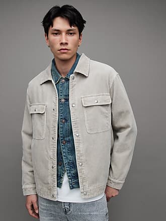 Man wearing a denim overshirt, white T-shirt and white pants with a luxury  brown monogrammed Loui in 2023