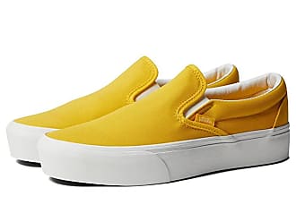 yellow and white vans slip on